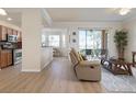 Open concept living area with kitchen, patio access, and neutral decor at 8403 Grand Estuary Trl # 106, Bradenton, FL 34212