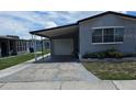 Mobile home with carport and driveway at 1710 7Th Sw St # 103, Ruskin, FL 33570