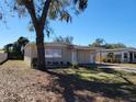 Charming single-story home with neutral paint and mature shade tree at 4305 E Deleuil Ave, Tampa, FL 33610