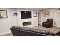 Living room with a modern fireplace and comfortable seating at 5053 N Beach Rd # 9, Englewood, FL 34223