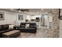 Open living room and kitchen area with modern finishes and leather sofas at 5053 N Beach Rd # 9, Englewood, FL 34223