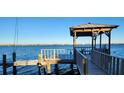 Wooden dock with gazebo offering scenic waterfront views at 5053 N Beach Rd # 9, Englewood, FL 34223