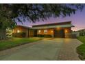 Evening view of single-story home with attached garage and brick paver driveway at 429 Flamingo Dr, Apollo Beach, FL 33572