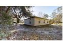 Single-story house exterior with light-colored walls at 17130 Pasco Acres Dr, Spring Hill, FL 34610