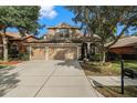 Two story home with three car garage and landscaping at 11140 Oyster Bay Cir, New Port Richey, FL 34654