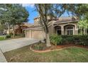 Two story home with three car garage and landscaping at 11140 Oyster Bay Cir, New Port Richey, FL 34654