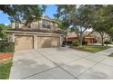 Two story home with three car garage and landscaping at 11140 Oyster Bay Cir, New Port Richey, FL 34654