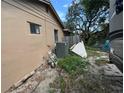 Rear view of house showing an AC unit and a partially fenced backyard at 6297 Harcross Ct, Spring Hill, FL 34606
