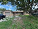 House exterior showcasing a ranch-style home with a yard and driveway at 6297 Harcross Ct, Spring Hill, FL 34606