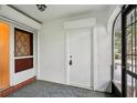 Front entry with white door and terracotta tile flooring at 1606 Laughton Pl, Sun City Center, FL 33573