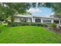 Charming home with lush landscaping and a well-maintained front yard at 1606 Laughton Pl, Sun City Center, FL 33573