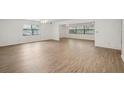 Large living room with wood floors, large windows, and neutral walls at 1606 Laughton Pl, Sun City Center, FL 33573