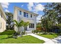 Stunning two-story home featuring a modern design and manicured landscaping at 2909 W Spruce St, Tampa, FL 33607