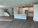 Open-concept kitchen with island, white cabinets, and hardwood flooring at 4017 W Fig St, Tampa, FL 33609