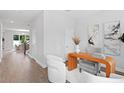 Open office area with modern desk, stylish chairs, and hardwood flooring throughout the home at 4017 W Fig St, Tampa, FL 33609