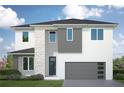 Two-story home with gray and white exterior, stone accents, and a two-car garage at 707 W Fribley St, Tampa, FL 33603