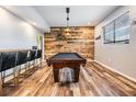 Game room with pool table and rustic wood wall at 11116 Hoffner Edge Dr, Riverview, FL 33579