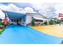 Mobile home exterior with carport and colorful landscaping at 7131 El Dewitt St, Zephyrhills, FL 33541