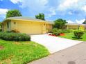 House exterior showcasing a yellow house with attached garage at 1306 Idlewood Dr # 53, Sun City Center, FL 33573