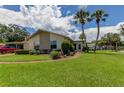 Landscaped home with two palm trees and driveway at 3283 Hilary Cir # 2C, Palm Harbor, FL 34684