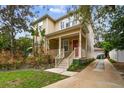 Two-story house with red door, driveway, and lush landscaping at 3104 W Fielder St, Tampa, FL 33611
