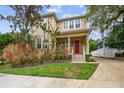 Two-story house with red door, front porch, and manicured lawn at 3104 W Fielder St, Tampa, FL 33611