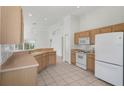 Bright kitchen with modern appliances and light wood cabinets is move-in ready at 11230 Heathrow Ave, Spring Hill, FL 34609