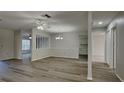 Open floor plan with light wood floors, a ceiling fan, and decorative columns separating the dining area at 2607 Royal Ridge Dr, Spring Hill, FL 34606