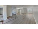 Bright and open living space featuring wood-look flooring, fresh paint, and plenty of natural light at 2607 Royal Ridge Dr, Spring Hill, FL 34606