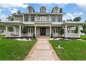 Grand two-story home with covered porch and landscaping at 638 Limona Woods Dr, Brandon, FL 33510