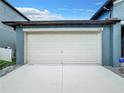 Attached two-car garage with white door at 13336 Great Plains Dr, Riverview, FL 33579