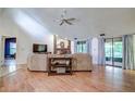 Inviting living room with vaulted ceilings, fireplace, and sliding glass doors to the outside at 35070 Smoketree Ln, Dade City, FL 33523