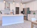 Modern kitchen featuring white cabinets, stainless steel appliances, and an island at 18390 Fremont Ave, Port Charlotte, FL 33954