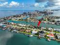 Gorgeous waterfront home with a dock, beautiful landscaping, and views of the bay and intercoastal waterway at 221 Howard Dr, Belleair Beach, FL 33786