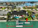Stunning waterfront property with a private pool, dock, 100 feet of linear footage, and direct water access at 221 Howard Dr, Belleair Beach, FL 33786