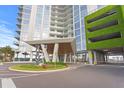 Modern building entrance with covered parking and landscaping at 5120 Marina Way # 8805, Tampa, FL 33611