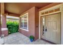 Covered front porch with tile flooring, window, and exterior door at 10906 Holly Cone Dr, Riverview, FL 33569