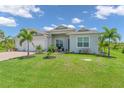 Charming house exterior with a three-car garage and lush landscaping at 13333 Gershwin Ln, Port Charlotte, FL 33981