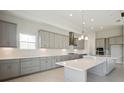 Modern kitchen with gray cabinetry, white countertops, and a large island at 10324 Longmeadow Ave, Parrish, FL 34219