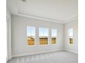Bright bedroom with three large windows and plush carpeting at 10426 Longmeadow Ave, Parrish, FL 34219