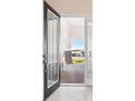 Open front door revealing a spacious entryway and paved patio at 10426 Longmeadow Ave, Parrish, FL 34219