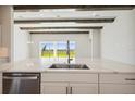 Kitchen island with quartz countertop and stainless steel appliances at 10422 Longmeadow Ave, Parrish, FL 34219