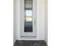 Front entry with light-colored door and paver walkway at 10422 Longmeadow Ave, Parrish, FL 34219