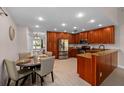 Well-lit kitchen with granite countertops, stainless steel appliances, and a cozy dining area at 2618 Crestfield Dr, Valrico, FL 33596