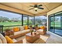 Inviting screened-in patio with comfortable wicker furniture and serene golf course views at 2618 Crestfield Dr, Valrico, FL 33596