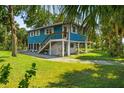 Charming waterfront home with a large deck and tropical landscaping at 10581 Pine Island Dr, Weeki Wachee, FL 34607