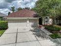 Two-car garage and well-maintained landscaping at 1438 Emerald Hill Way, Valrico, FL 33594