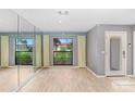 Light and bright entryway with wood floors and large mirror at 1826 Wolf Laurel Dr, Sun City Center, FL 33573
