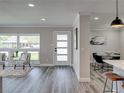 A cozy living room with wood floors, light walls and a dining area viewable from the entry at 120 Chesapeake Ave, Tampa, FL 33606