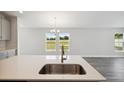 Kitchen island with sink and stainless steel faucet at 12378 Oak Hill Way, Parrish, FL 34219